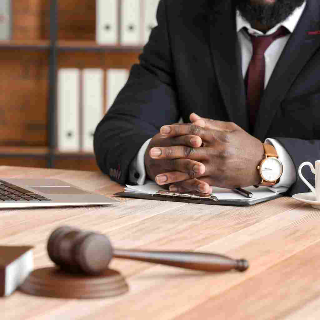 An attorney at his desk with his hands crossed