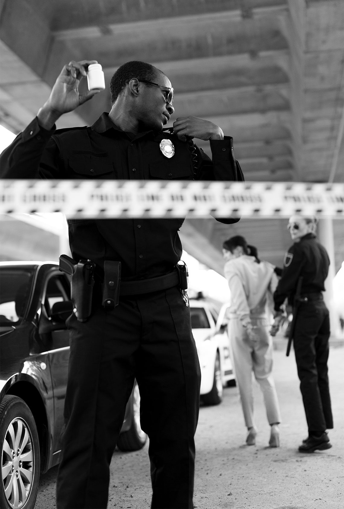police crime scene police officer guarding crime scene as woman is placed in cop car for illegal drug possession charges in michigan