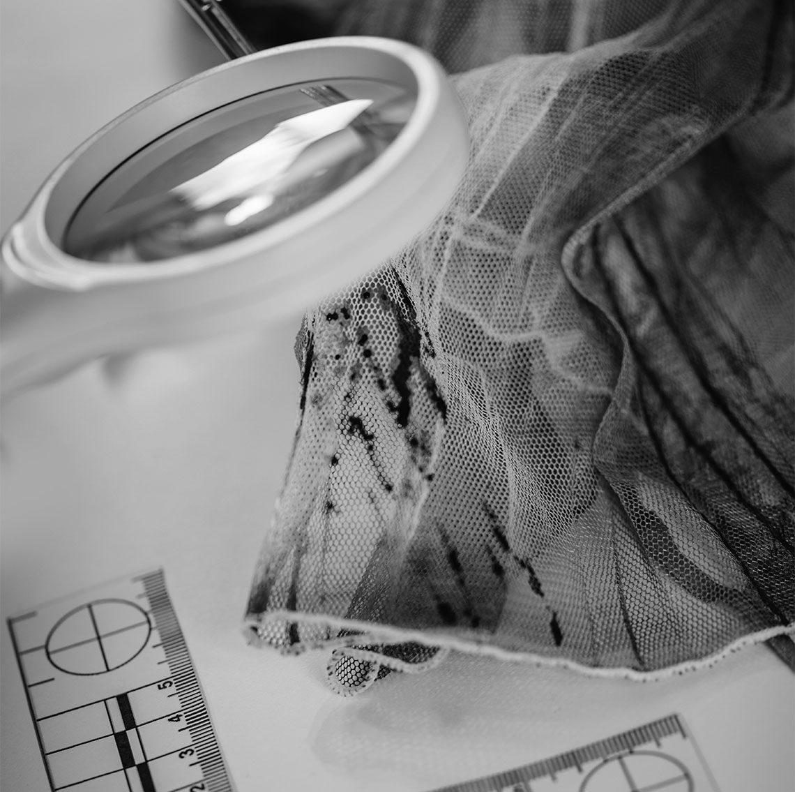 drug scene forensic evidence close up of magnify glass and cloth for forensic analysis of drugs