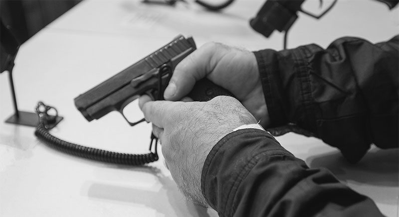 man holding pistol at gun shop close up of hands holding pistol at gun shop
