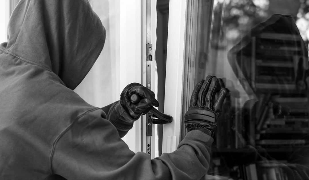 Home Invasion Defense in Michigan masked man using crow bar to break into a home committing criminal home invasion